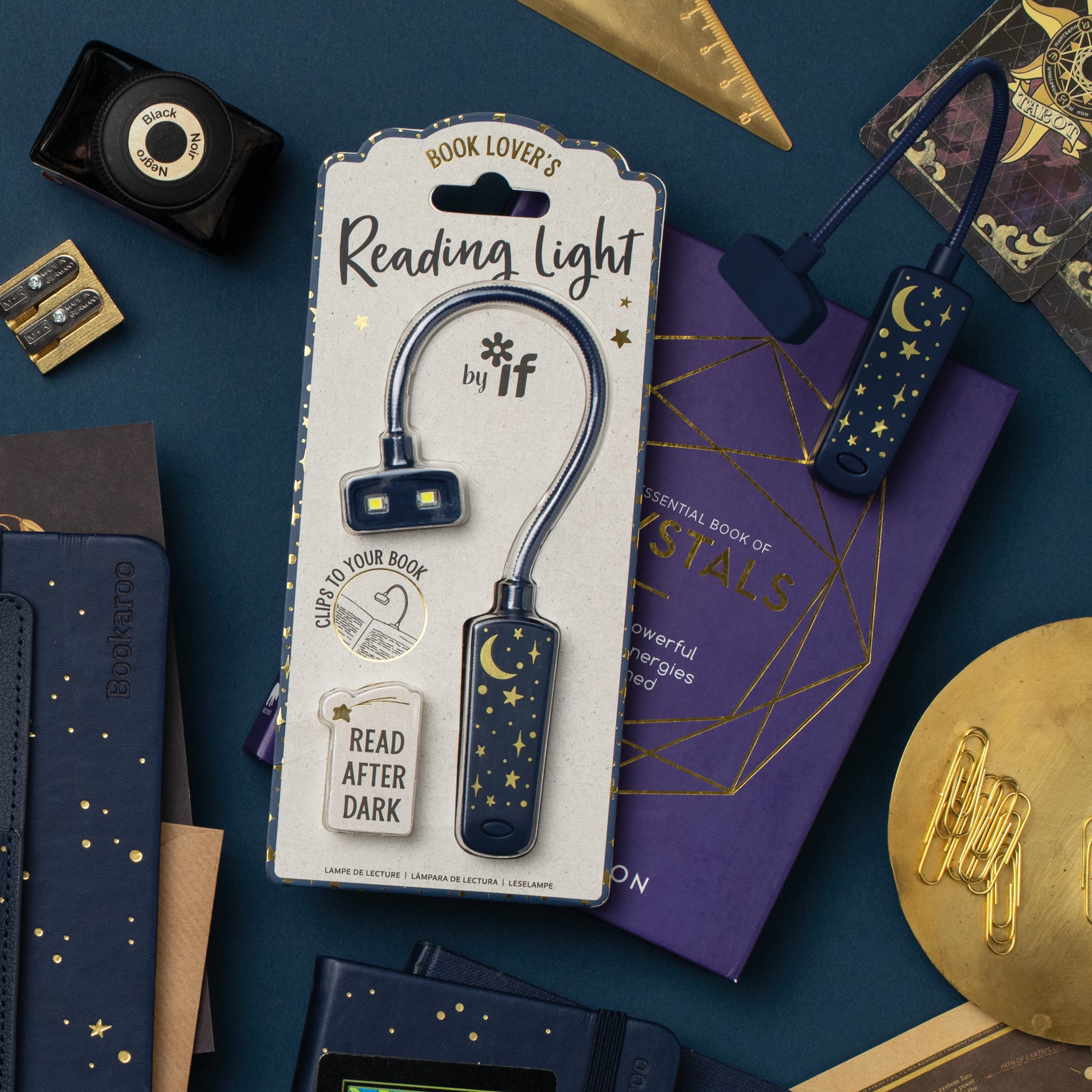Book Lover's Reading Light packaging on a dark blue background with books and decorative items.