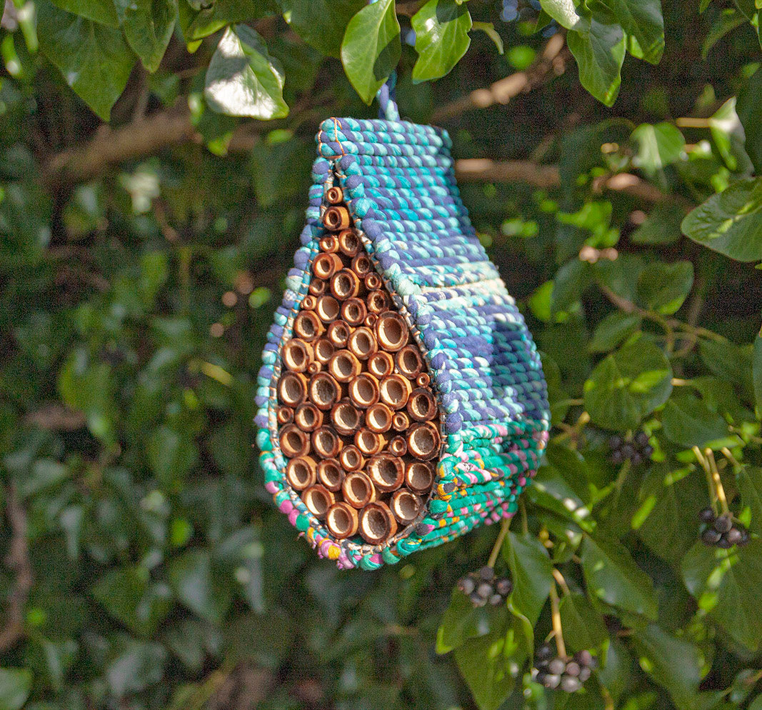 Image of blue Artisan Bee Nester hanging in a tree