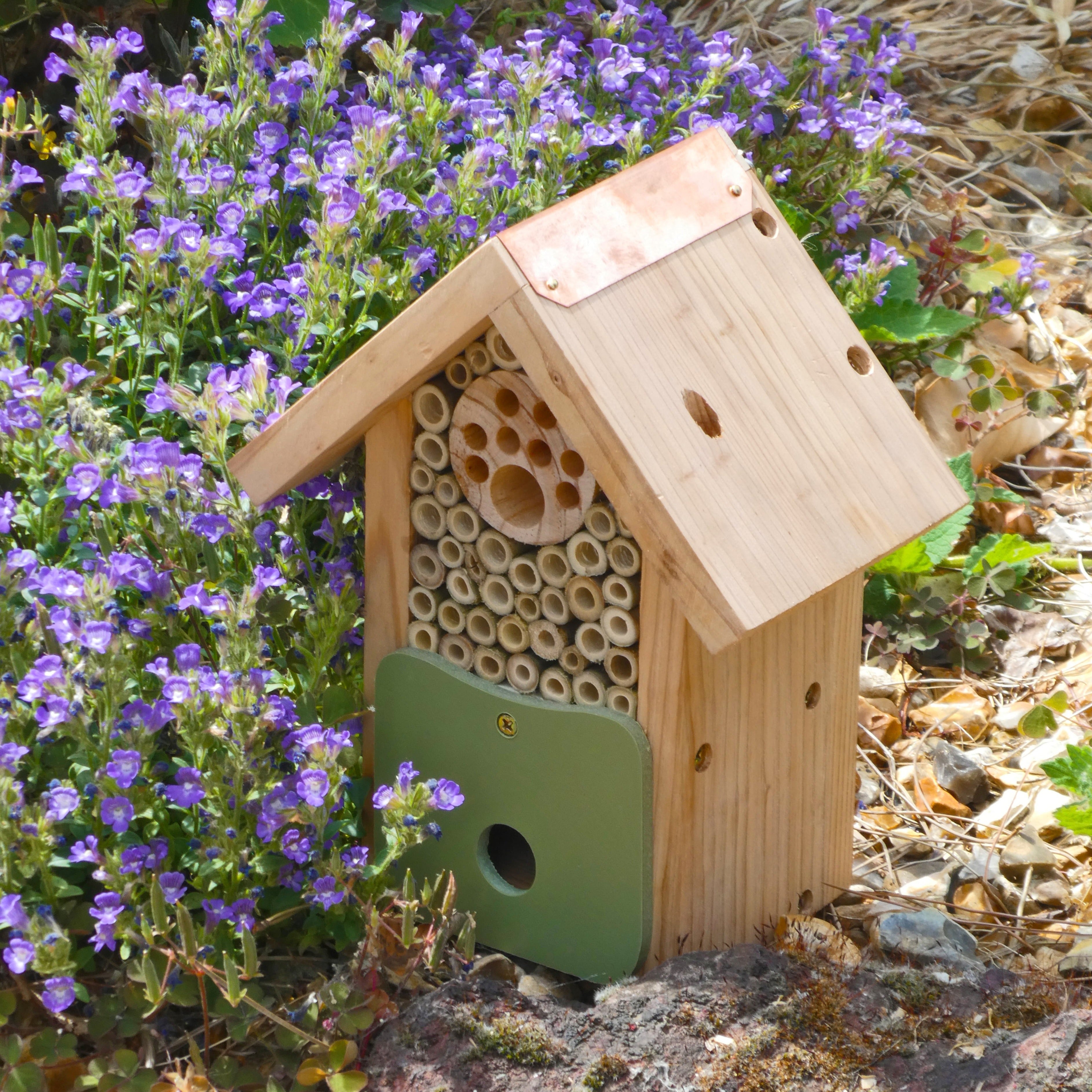 Front image of Artisan Bee Barn sat among flowers