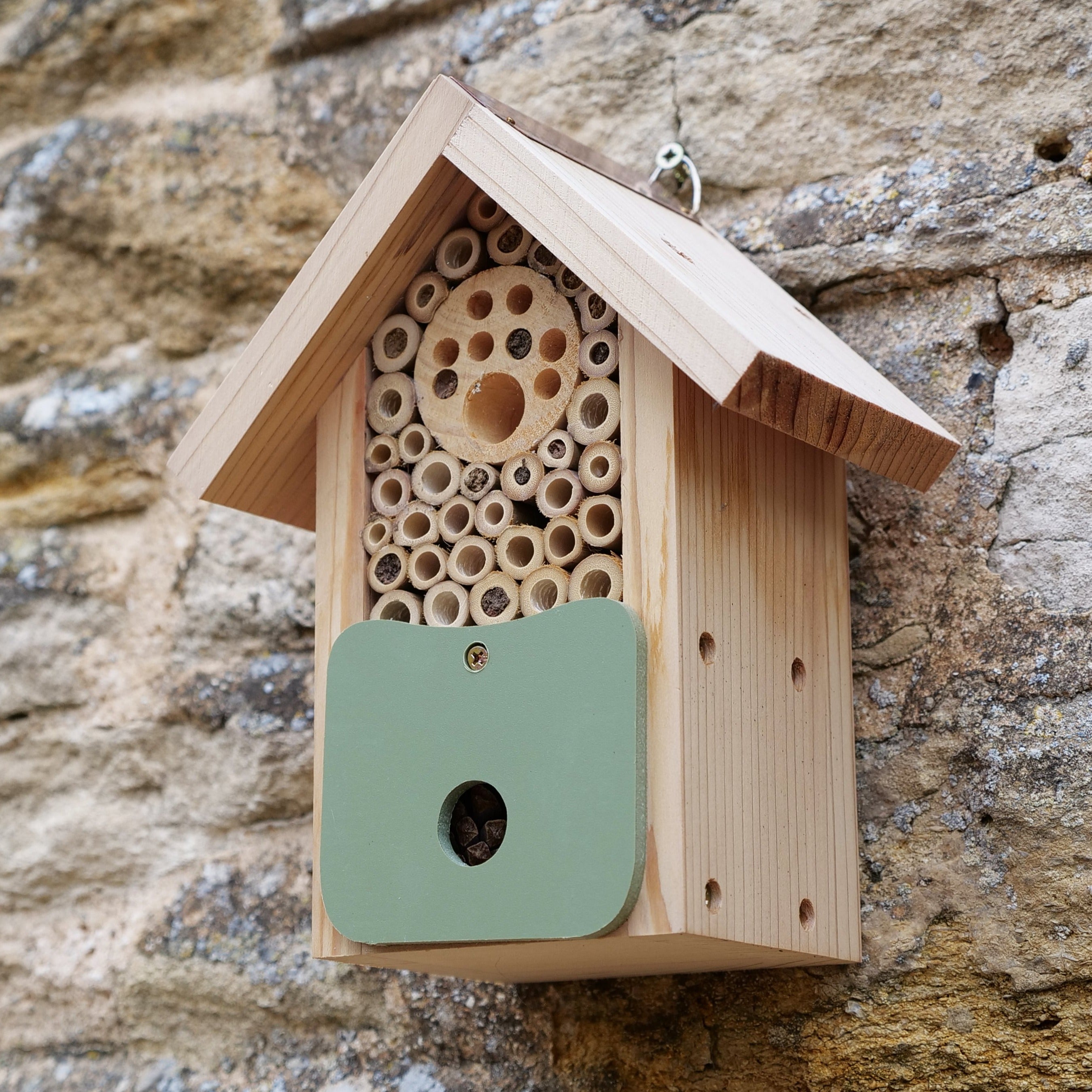 Side image of Artisan Bee Barn attached to a stone wall