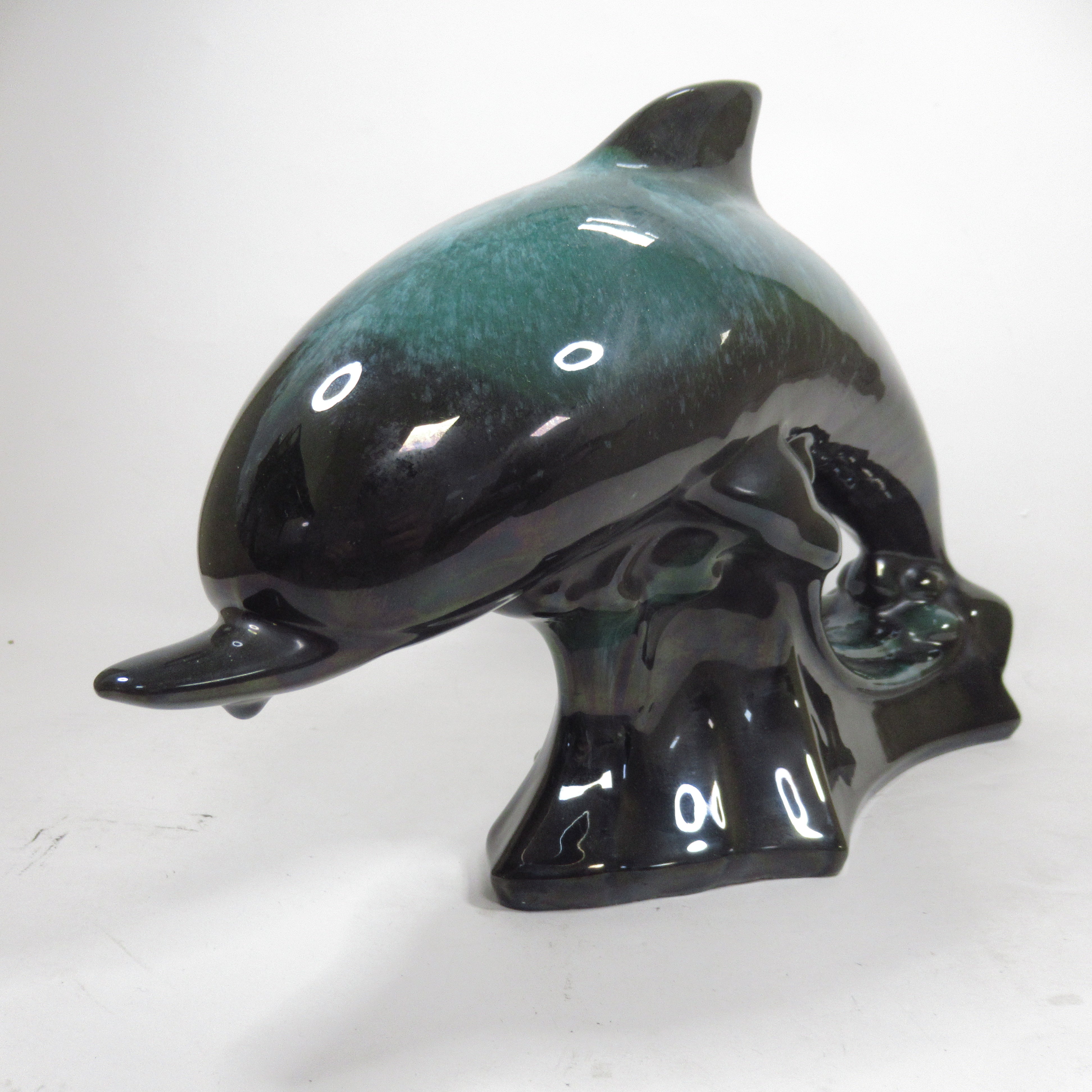 Front image of Blue Mountain Pottery Teal Green Wave Jumping Dolphin