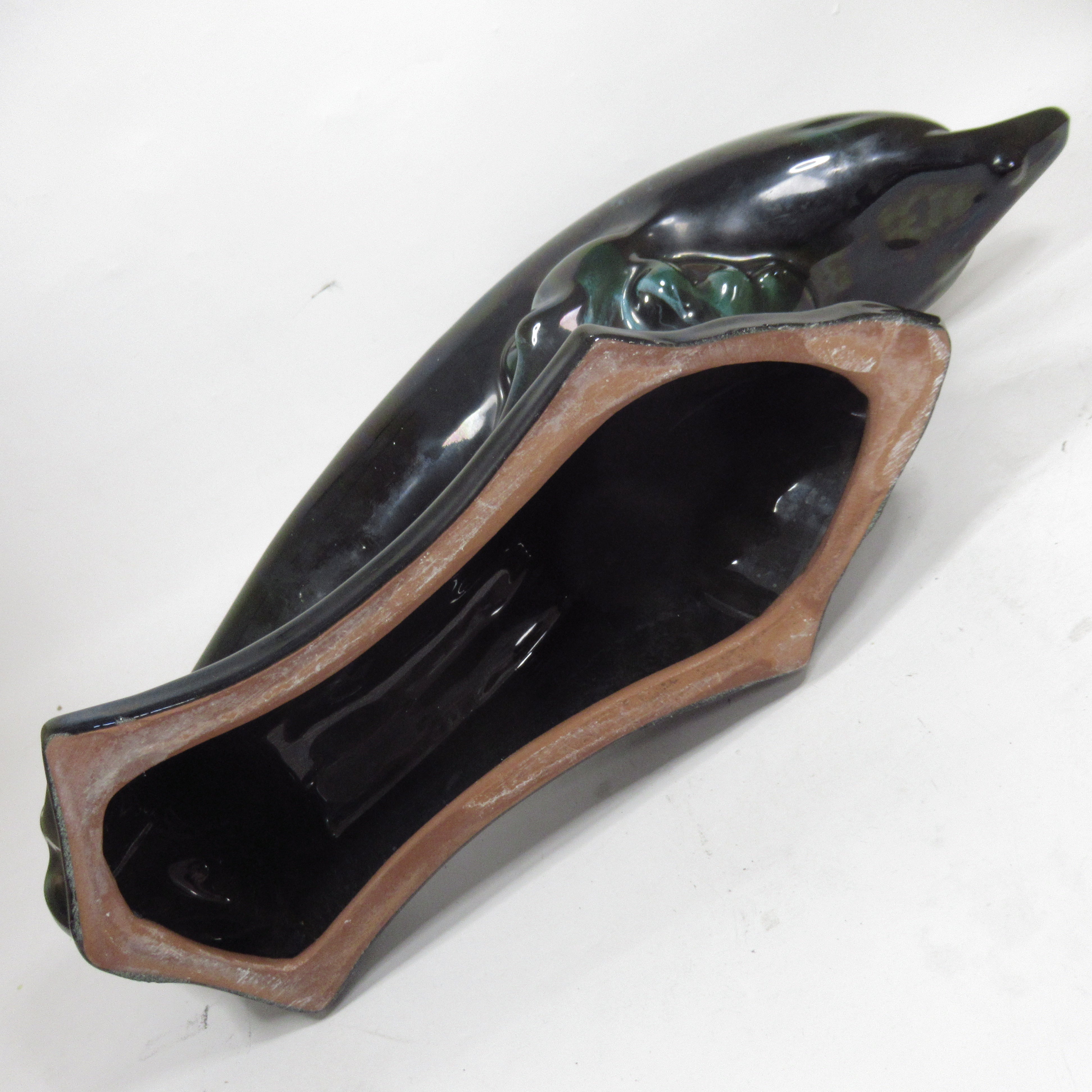 Underside view of Blue Mountain Pottery Teal Green Wave Jumping Dolphin