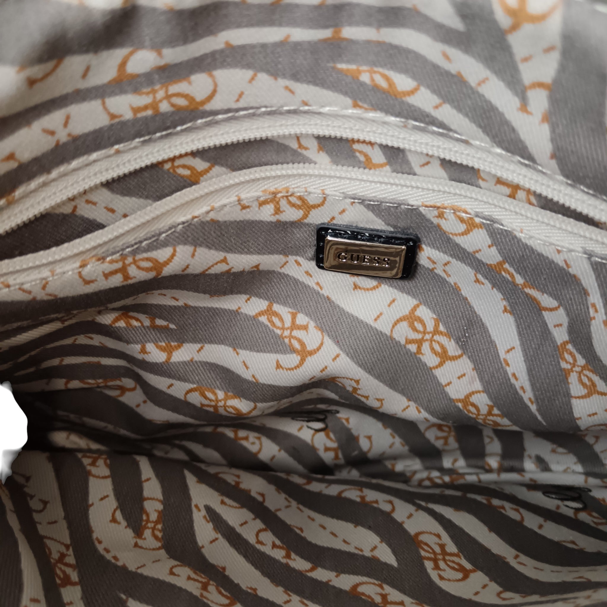 Lining image for Vintage GUESS Brown Monogram with Purple Animal Print Trim Studded Ladies Clutch Bag- Womenswear | Pre-loved