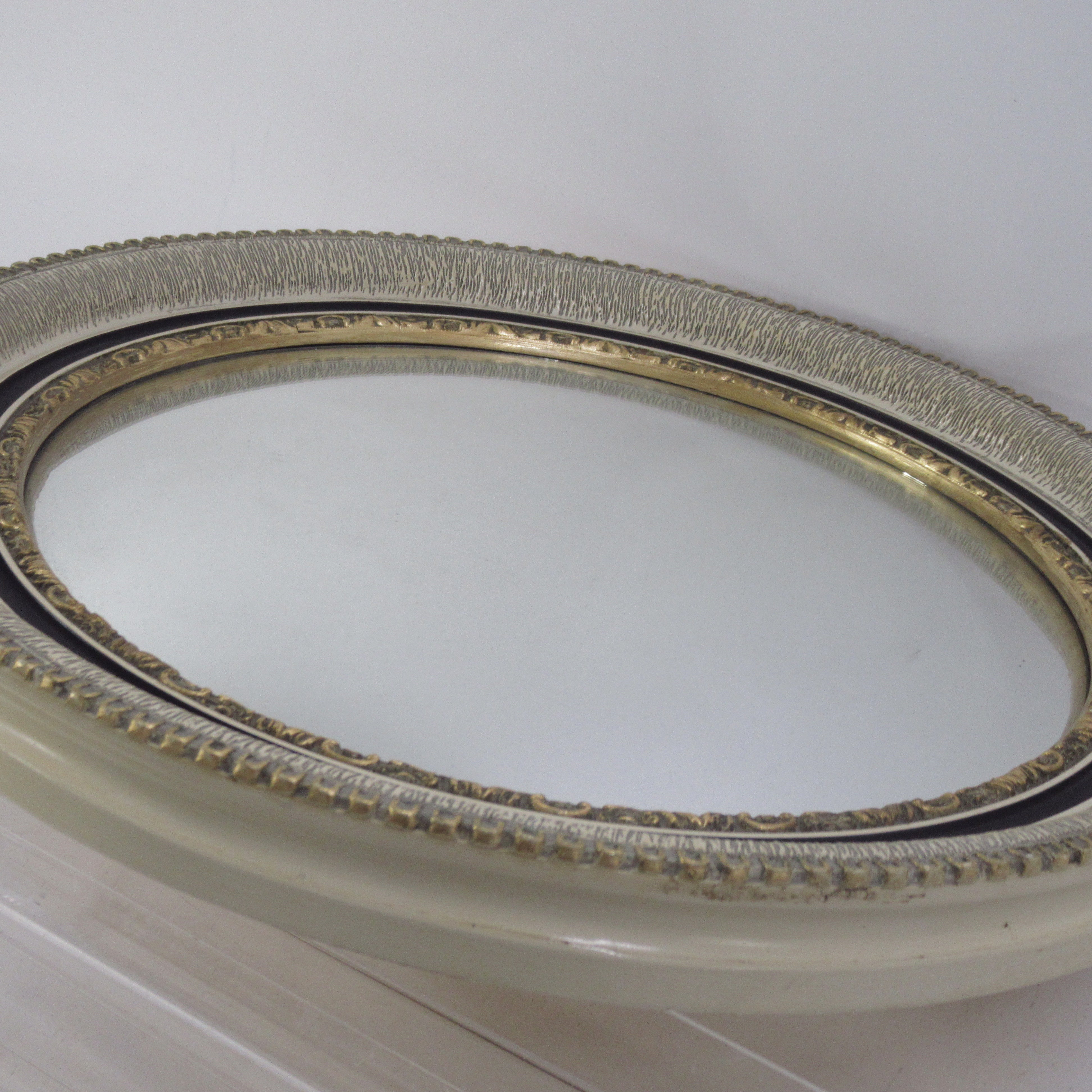 Side image of Atsonea Oval Wall Mirror with Ornate Trim