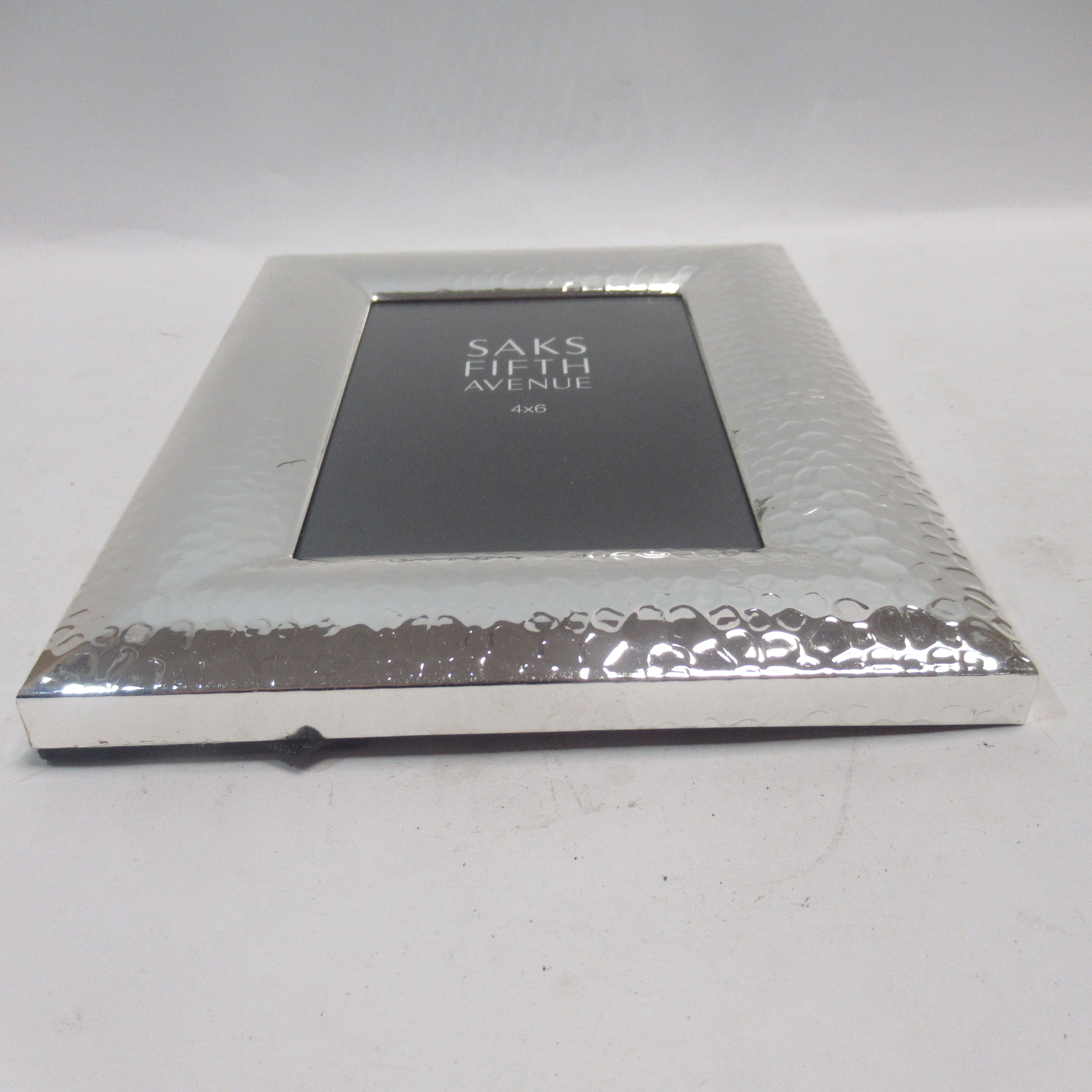 Underside edge image of Saks Fifth Avenue Silver Metal Hammered 4x6" Photo Frame