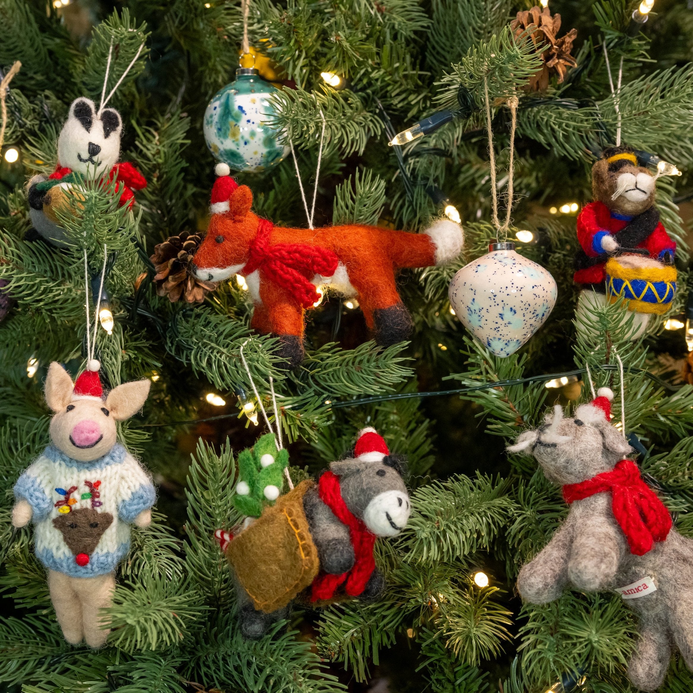 Group image of multiple felt decorations on a Christmas tree