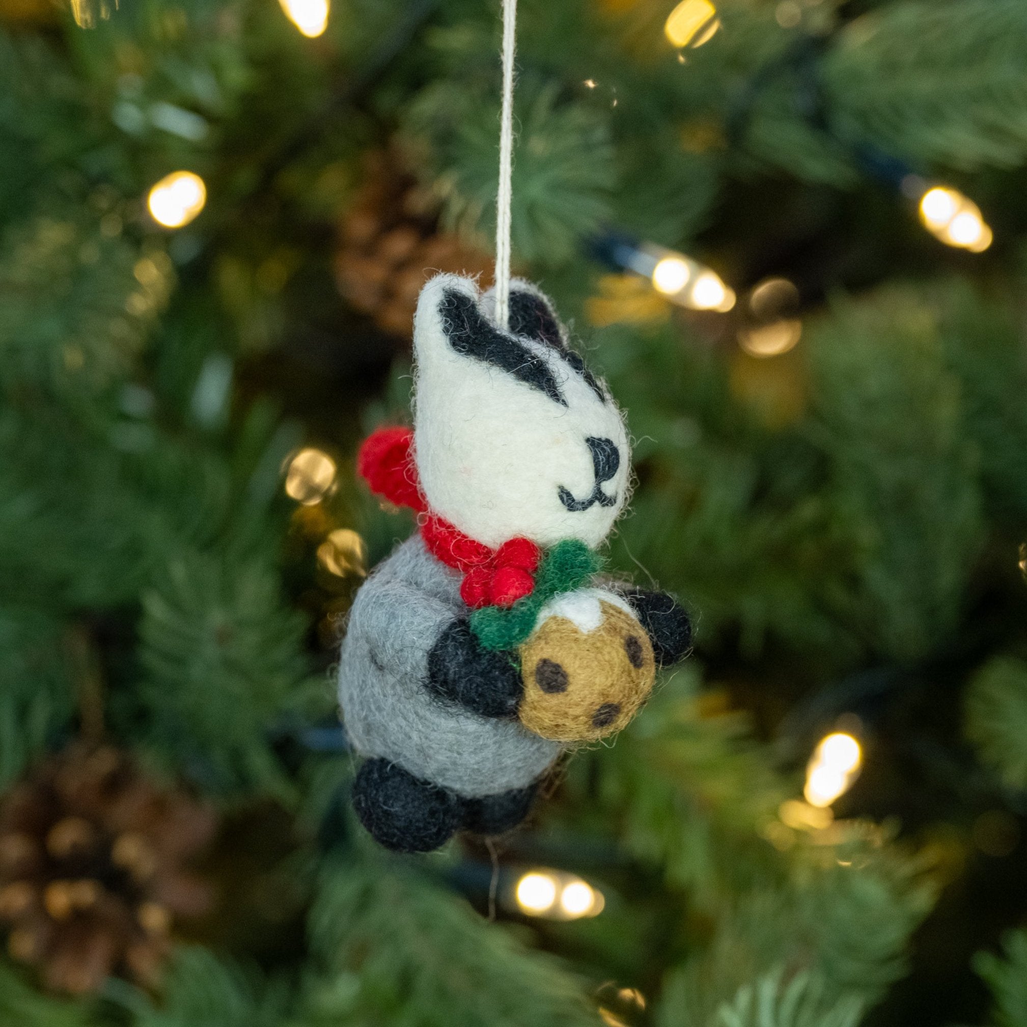 Side view of Badger with Christmas Pudding handmade felt decoration