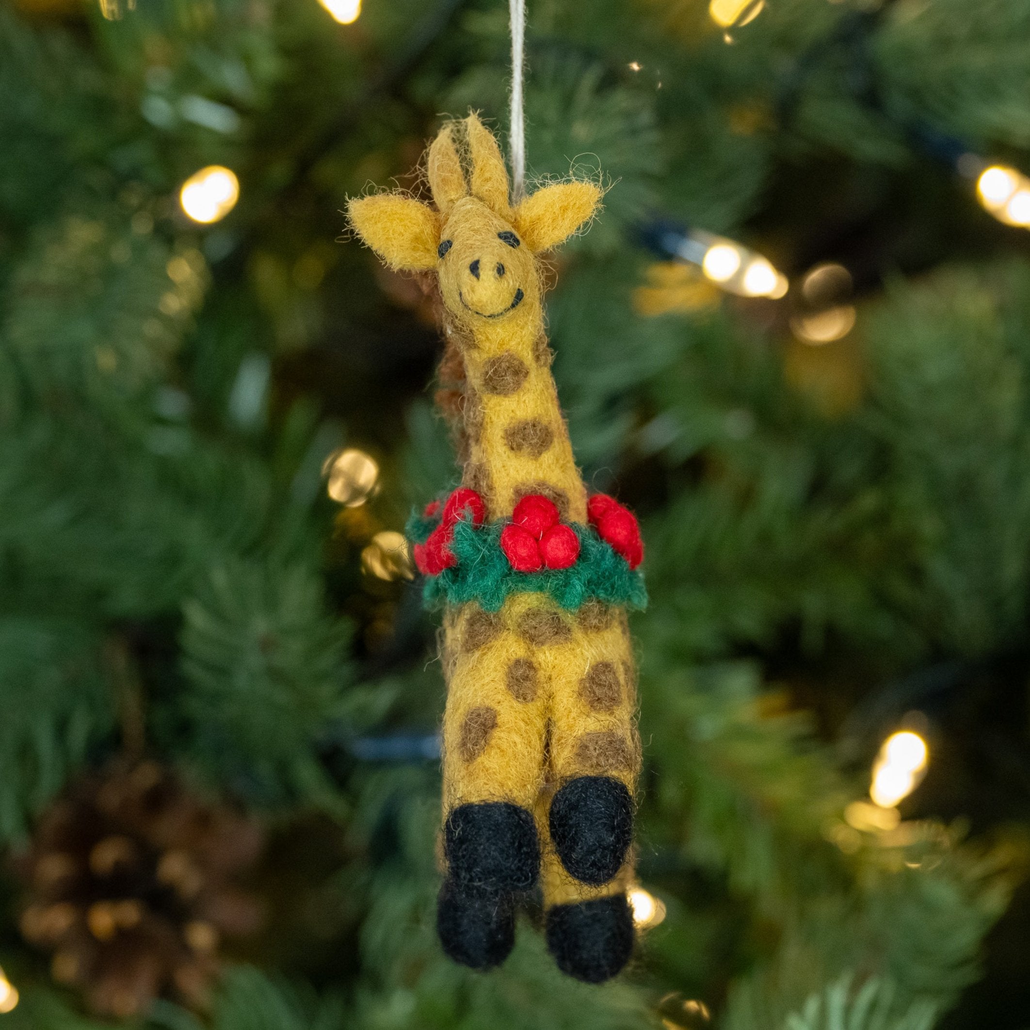 Front view of Giraffe with Holly Wreath Handmade, Fairtrade Felt Christmas Decoration